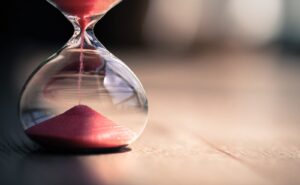 Red sand in an hourglass. Time may be ticking away, but that doesn't mean you have to mistime a stock market valuation.