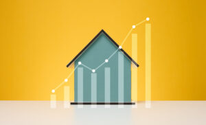 Wooden house and a graph with growing indicators. Rising propert