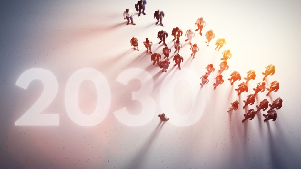 Overhead view of diverse business professionals walking toward the number 2030, symbolizing business strategy in the 2030’s, future planning, economic shifts, leadership preparation, and long-term strategic transformation.
